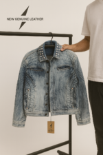 Flat lay of denim jacket with jeans, t-shirt, and accessories styling guide