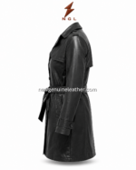Back view of black leather trench coat with shoulder storm flap, center back seam, waist belt, cuff straps, and white studio background.