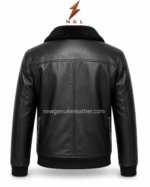 Black shearling jacket detail showing plush black collar, smooth leather grain, shoulder stitching, and front zipper design.