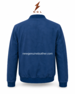 Blue suede jacket detail showing ribbed knit collar, silver zipper, soft suede texture, and minimal panel design.