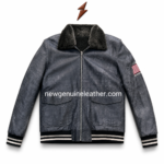 Charcoal shearling bomber jacket inner view showing black sherpa lining, open zipper, plush collar and sleeve
