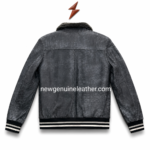 Charcoal shearling bomber jacket close-up with black plush collar, grey distressed leather texture and OEM-ready stitching.