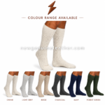 Cream lederhosen socks worn on legs with raised cable-knit texture and ribbed top cuff on white background