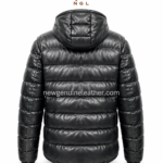 Leather puffer jacket back pose showing attached hood, horizontal padded panels, glossy black leather texture