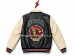 Leather varsity jacket manufacturer back view with black leather body, cream sleeves, large football-style patch, and striped waistband