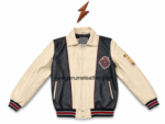 Black and cream leather varsity jacket detail with side welt pockets, red piping, ribbed cuffs, and leather patch placement