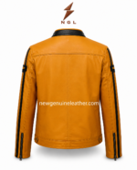 Mustard biker jacket detail showing Victory patch, Freedom shield patch, black zipper pocket, and smooth mustard leather surface.