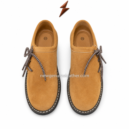 Tan Oktoberfest suede shoes featuring camel suede texture, rounded toe, black treaded sole, white sole stitching, and black-and-white round laces
