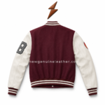 Women’s patch varsity jacket with maroon body, cream sleeves, striped rib collar, black P patch, grey 9 patch, flame sleeve patch, and NGL