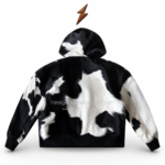NGL cowhide hooded jacket neckline close-up with black-and-white hair-on leather, silver zipper, stitching, and hidden logo label